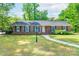 Charming brick home features a well-maintained lawn, elegant lamp post, and vibrant hydrangea bushes, exuding timeless appeal at 5720 Amity Pl, Charlotte, NC 28212