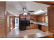 Eat-in kitchen features wood cabinets, black appliances, laminate flooring, and a ceiling fan at 5720 Amity Pl, Charlotte, NC 28212