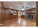 Wood-paneled living room features a brick fireplace and hardwood floors, blending rustic charm with a cozy, inviting ambiance at 5720 Amity Pl, Charlotte, NC 28212