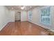 Spacious living room featuring gleaming hardwood floors and abundant natural light, offering a bright and welcoming atmosphere at 5720 Amity Pl, Charlotte, NC 28212