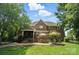 Expansive backyard with patio, outdoor kitchen, and lush landscaping offers ample space for outdoor living at 5916 Four Wood Dr, Matthews, NC 28104