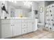 Bright bathroom with double sink vanity, framed mirror, and decorative accents at 5916 Four Wood Dr, Matthews, NC 28104