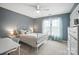 Bright bedroom featuring a white iron bed frame, large window with sheer curtains, and a desk setup at 5916 Four Wood Dr, Matthews, NC 28104