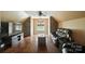 Cozy bonus room featuring hardwood floors, stone accent walls, and a comfortable leather couch at 5916 Four Wood Dr, Matthews, NC 28104