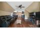 Spacious bonus room with hardwood floors, stone accent wall, entertainment center, and comfortable seating at 5916 Four Wood Dr, Matthews, NC 28104