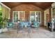 Charming covered porch featuring comfortable seating, a beverage cooler, and serene outdoor ambiance at 5916 Four Wood Dr, Matthews, NC 28104