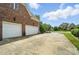 The long concrete driveway leads to the attached two-car garage and lush backyard at 5916 Four Wood Dr, Matthews, NC 28104