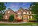 Beautiful brick two-story home with manicured lawn and mature landscaping creates amazing curb appeal at 5916 Four Wood Dr, Matthews, NC 28104