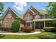 Lovely brick two-story home with manicured lawn and mature landscaping, a great place to create memories at 5916 Four Wood Dr, Matthews, NC 28104