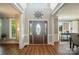 Inviting foyer with a beautiful wooden door, natural light, and neutral colors giving a luxurious feel at 5916 Four Wood Dr, Matthews, NC 28104