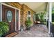 Relaxing front porch with stone accents, plants, pillows and swing, a great place to relax with friends at 5916 Four Wood Dr, Matthews, NC 28104