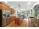 Bright kitchen features stainless steel appliances, central island with stovetop, granite countertops, and an adjacent breakfast area at 5916 Four Wood Dr, Matthews, NC 28104