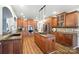 Large kitchen with custom cabinets, granite counters, hardwood floors, and a center island with gas cooktop at 5916 Four Wood Dr, Matthews, NC 28104