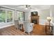 Cozy living room with fireplace, mantle, large windows, and comfortable seating creating a warm atmosphere at 5916 Four Wood Dr, Matthews, NC 28104