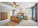 Main bedroom with tray ceiling, large windows with patterned curtains, wood furniture, and neutral paint at 5916 Four Wood Dr, Matthews, NC 28104
