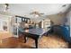 Recreation room with a ping pong table, wet bar area, hardwood flooring, and ample space for entertaining at 5916 Four Wood Dr, Matthews, NC 28104