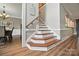 Well-lit staircase featuring wood treads and white risers, leading to the upper level of the home at 5916 Four Wood Dr, Matthews, NC 28104
