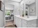 Bright, dual sink bathroom with tile floors, white cabinets, and access to bedroom provides a modern space at 5995 Granbury Dr, Kannapolis, NC 28081