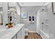 Well-lit bathroom featuring double sinks, white cabinets, and shower/tub combo offers a refreshing and convenient space at 5995 Granbury Dr, Kannapolis, NC 28081