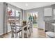 Sunlit dining area with wood floors, stylish decor, and views of the landscaped backyard at 5995 Granbury Dr, Kannapolis, NC 28081
