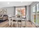 Elegant dining area with wood floors, large windows, and comfortable seating for Gathering gatherings at 5995 Granbury Dr, Kannapolis, NC 28081
