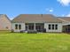Spacious backyard featuring a covered patio and lush green lawn, perfect for outdoor activities at 6020 Waldorf Ave, Monroe, NC 28110