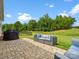 Serene patio with outdoor seating, a grill, and a large backyard with lush green grass at 6020 Waldorf Ave, Monroe, NC 28110