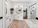 A bright bathroom featuring dual sinks, modern fixtures, and a glass-enclosed shower with tile surround at 6020 Waldorf Ave, Monroe, NC 28110