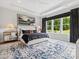This spacious bedroom features a large window, stylish rug, and a comfortable bed with modern decor at 6020 Waldorf Ave, Monroe, NC 28110