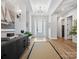 Bright foyer with hardwood floors, tray ceiling, decorative lighting, and a view of the front door at 6020 Waldorf Ave, Monroe, NC 28110