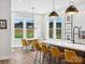 Bright, open kitchen features a large island, modern lighting, and sunny breakfast nook with backyard views at 6020 Waldorf Ave, Monroe, NC 28110