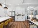 The kitchen features stainless steel appliances and white cabinets with a metallic backsplash accent at 6020 Waldorf Ave, Monroe, NC 28110