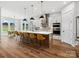 Open kitchen featuring a large island with seating, stainless steel appliances, and hardwood floors at 6020 Waldorf Ave, Monroe, NC 28110