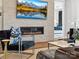 Stylish living room with tiled fireplace, wall-mounted TV, and a peek into the main bedroom at 6020 Waldorf Ave, Monroe, NC 28110