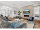 Bright and airy living room with a tiled fireplace, wall-mounted TV, and modern decor at 6020 Waldorf Ave, Monroe, NC 28110