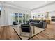 Open living room with fireplace, tv, sliding doors and views of the kitchen at 6020 Waldorf Ave, Monroe, NC 28110