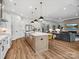 Open-concept living space with a kitchen, island seating, and a cozy living area at 6020 Waldorf Ave, Monroe, NC 28110