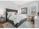 Comfortable main bedroom with a gray upholstered bed frame, white linens, and a patterned accent rug at 6020 Waldorf Ave, Monroe, NC 28110