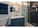 Bathroom with modern vanity, marble countertop, gold fixtures and herringbone shower at 617 Pinecrest St, Davidson, NC 28036