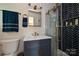 Modern bathroom featuring herringbone tile shower, updated vanity and fixtures at 617 Pinecrest St, Davidson, NC 28036