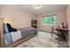 Neutral bedroom featuring storage bed, area rug, and natural light at 617 Pinecrest St, Davidson, NC 28036