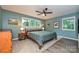 Bedroom with gray carpet, ceiling fan, and large windows at 617 Pinecrest St, Davidson, NC 28036