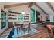 Spacious dining area featuring wood floors, shelving, and a view of the fireplace at 617 Pinecrest St, Davidson, NC 28036