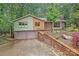 Charming home featuring a two-car garage, brick accents, lush landscaping, and a private drive at 617 Pinecrest St, Davidson, NC 28036