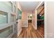 Inviting foyer featuring wood floors, a modern front door, and an open view into the kitchen at 617 Pinecrest St, Davidson, NC 28036