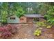 Charming home with colorful facade, landscaped front yard, and stone walkway leading to the front door at 617 Pinecrest St, Davidson, NC 28036