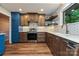Updated kitchen with stainless appliances, wood floors, white countertops, and geometric backsplash at 617 Pinecrest St, Davidson, NC 28036