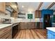 Updated kitchen with stainless appliances, wood floors, white countertops, and geometric backsplash at 617 Pinecrest St, Davidson, NC 28036