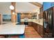 Modern kitchen with stainless steel appliances, breakfast bar, wood floors, and beautiful countertops at 617 Pinecrest St, Davidson, NC 28036