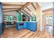 Kitchen with wooden floors, cathedral ceiling, wood beams, dining area, and blue island at 617 Pinecrest St, Davidson, NC 28036